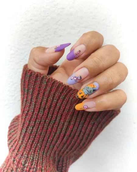 Matte purple nails with candy and black cat halloween nails