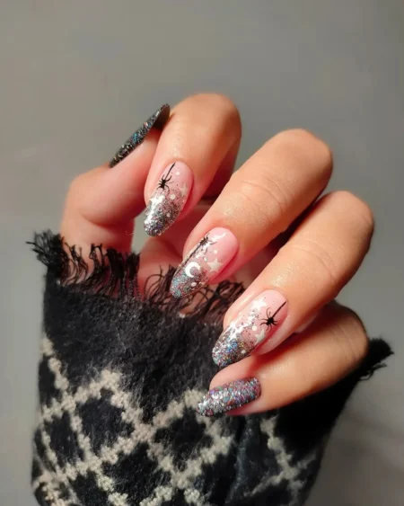 Nude nails with silver glitter stars moons and black spiders