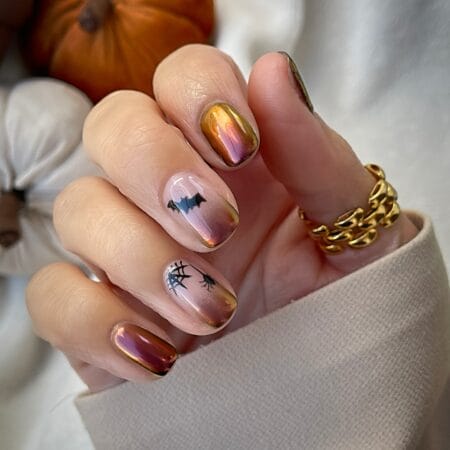 Copper chrome nails with black bat and spider web halloween nails