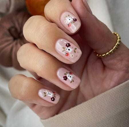 Milky nude nails with white ghosts and burgundy flowers halloween nails