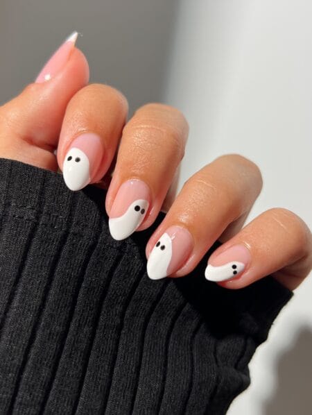 Nude almond nails with bold white ghost designs halloween nails