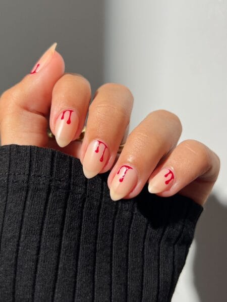 Nude almond nails with red blood drip French design