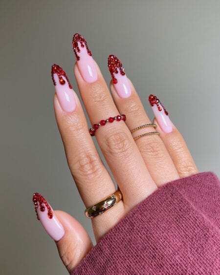 Long pink nails with cascading red crystal blood drips halloween nails