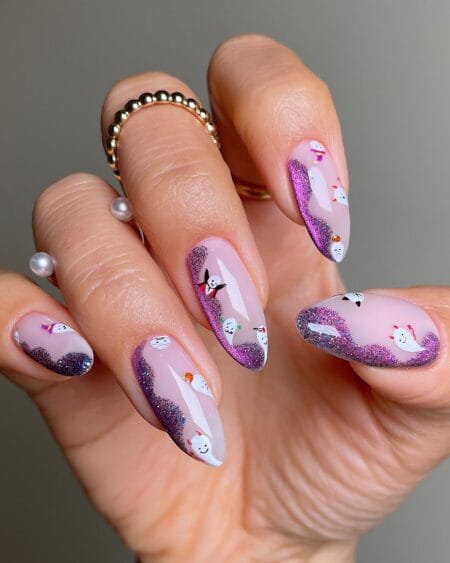 Nude nails with purple glitter and cartoon ghosts halloween nails