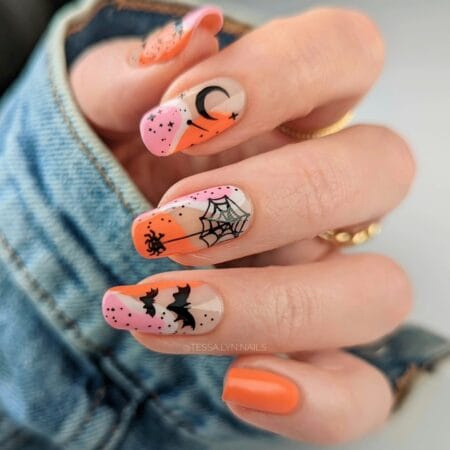 Long nails with pink and orange bats spiders and webs halloween nails