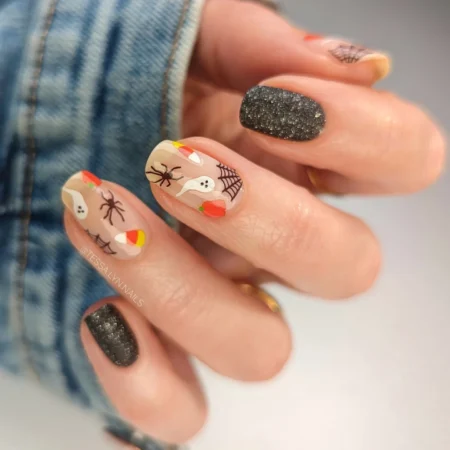 Nude nails with candy corn ghosts spiders and webs