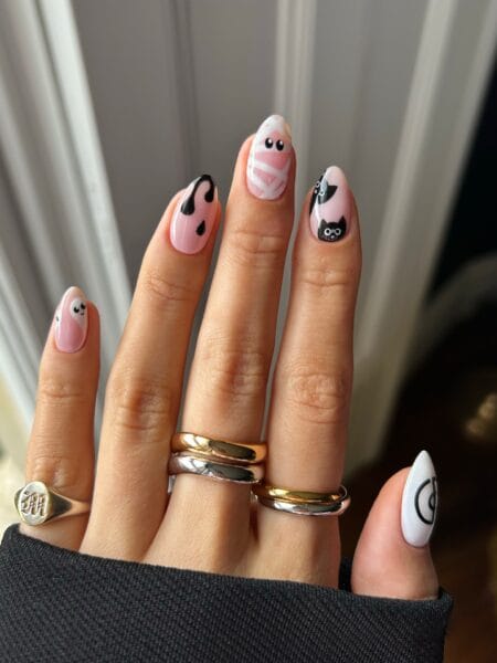 Pink and white nails with ghost mummy and black cat halloween nails