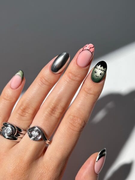 Almond nails with silver chrome green cat eye and Frankenstein