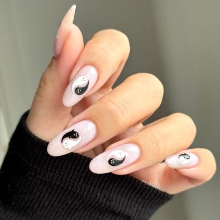 Pale pink almond nails with black and white yin yang ghost design