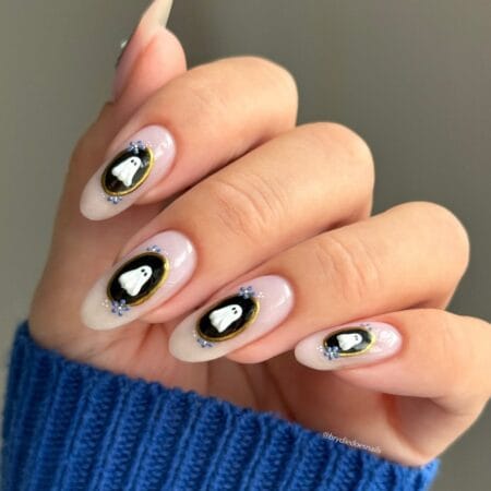Almond nails with black cameo ovals and white ghost halloween nails