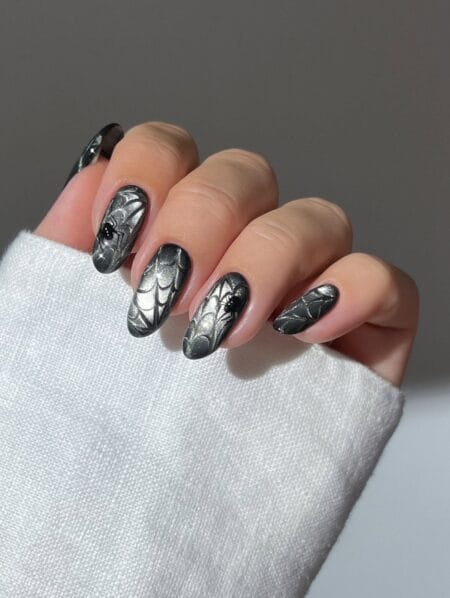Silver chrome nails with spider webs and black spiders