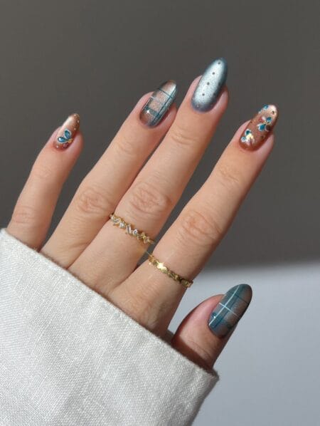 Brown and beige plaid nail art on almond-shaped nails.