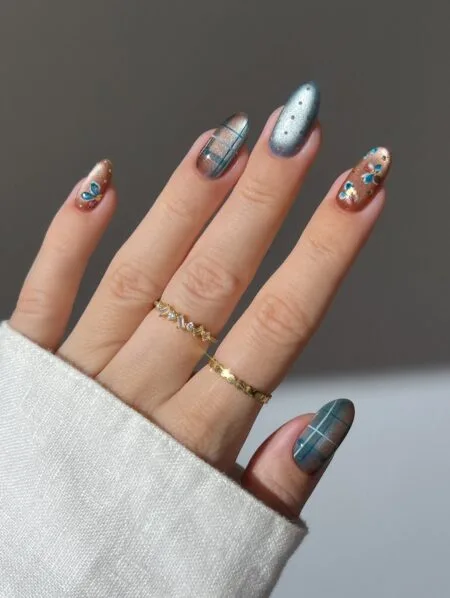 Brown and beige plaid nail art on almond-shaped nails.