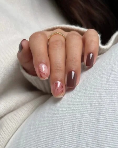 Caramel latte nails with warm brown swirl details.