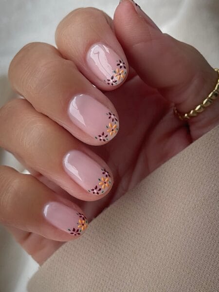 Short nails with tiny autumn florals painted at the tips