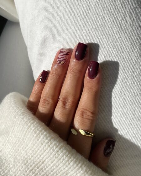 Short square plum nails with a zebra print accent nail