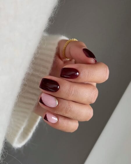 Short square nails in mulberry with gold glitter French tips