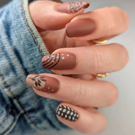 Matte terracotta nails with black line, dot and branch detail