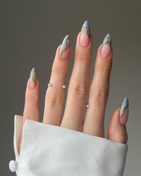 Almond nails with dusty blue side French and gold line detail