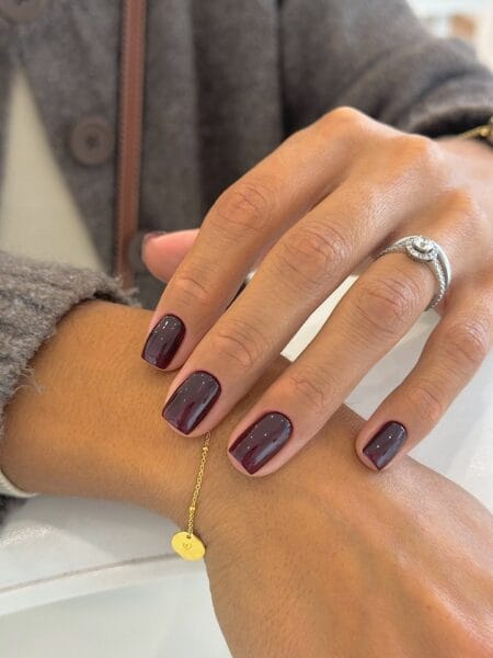 Short square nails painted in glossy oxblood for autumn