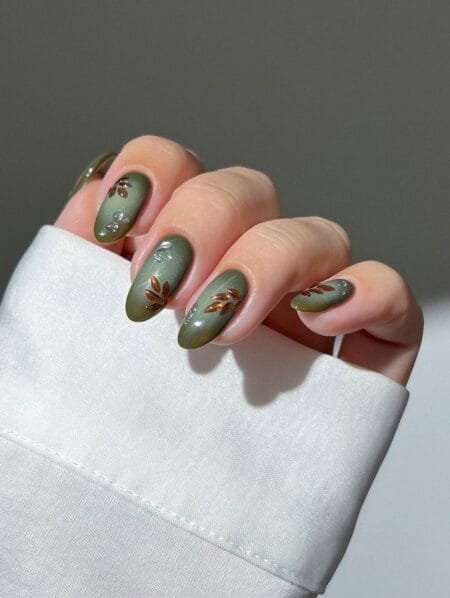 Olive green velvet nails with copper leaf crystal detail