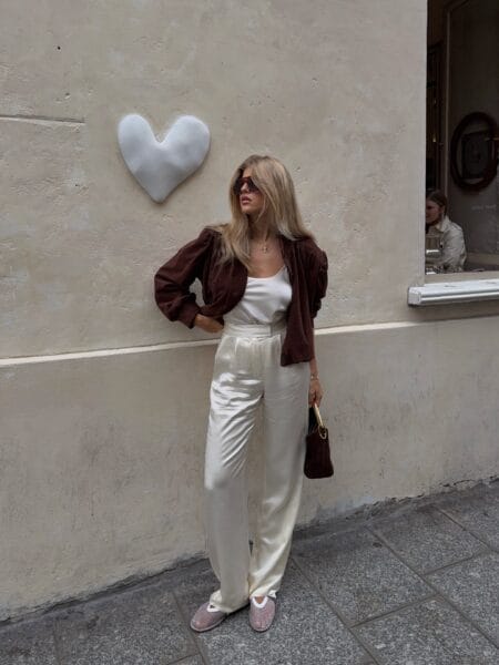 October outfit with brown suede puff-sleeve jacket and cream satin trousers