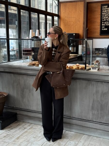 Autumn outfit with belted brown suede blazer, striped polo knit and black wide-leg trousers