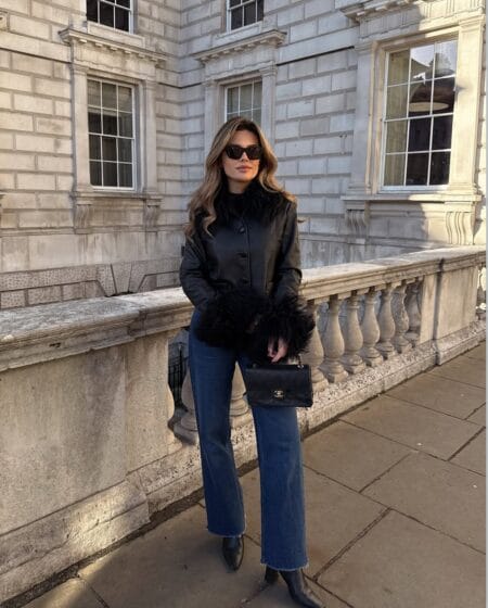 October outfit with black feather-trim leather jacket, dark wide-leg jeans and ankle boots