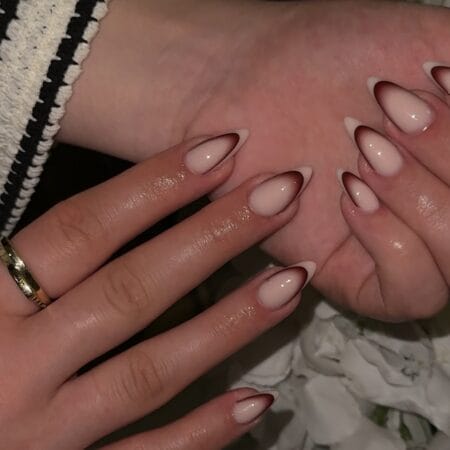 Almond nails with a thin chocolate brown micro French line on a milky nude base
