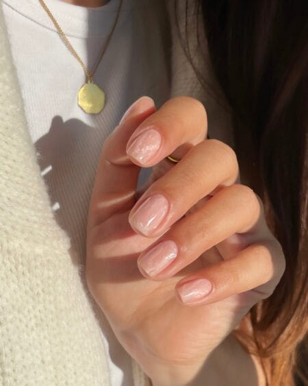 Short square nails in translucent rose with soft white marble veining
