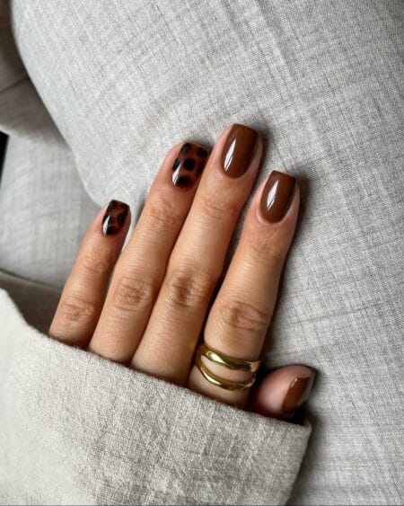 Glossy chocolate brown short square nails with black and amber leopard accents