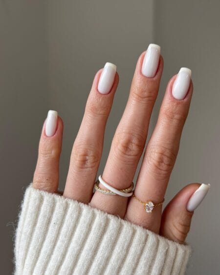 Short square nails in milky white with a soft cream French tip