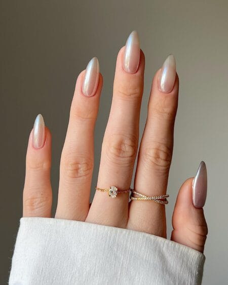 Almond nails with a sheer pearl glaze shifting between gold and lilac