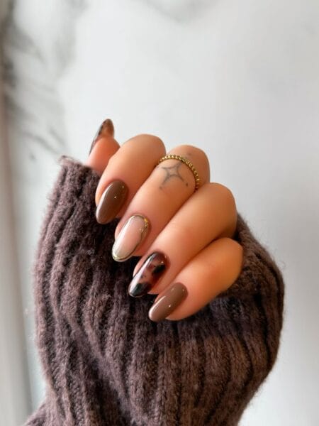 Taupe brown almond nails with gold chrome and tortoiseshell accent fingers
