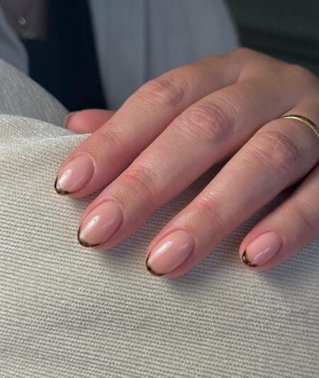 Nude almond nails with slim tortoiseshell French tips in amber and dark brown