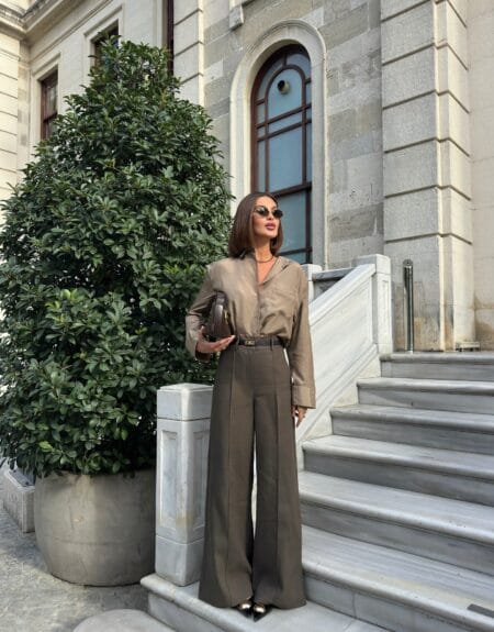 Khaki silk shirt and matching khaki wide-leg trousers with black pointed heels