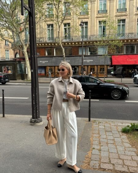 Oatmeal wool overshirt over a Breton stripe top with cream wide-leg trousers and two-tone flats