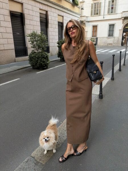 Brown linen waistcoat and matching column skirt with black quilted chain bag in Milan