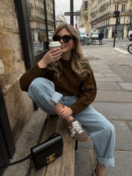 Olive brown crew-neck jumper with baggy light-wash jeans and brown suede trainers