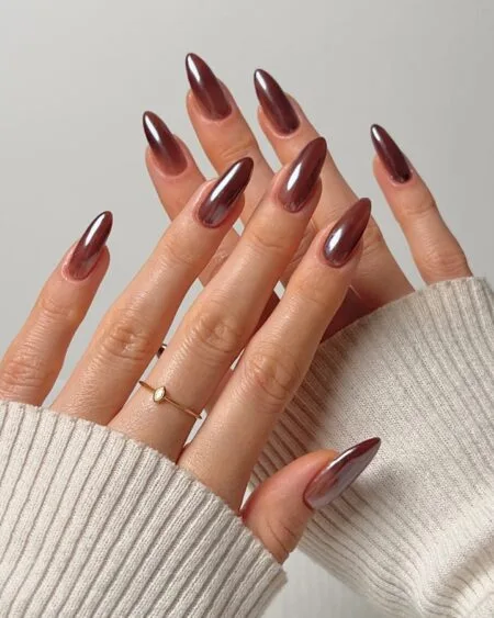 Caramel latte nails with warm brown swirl details.