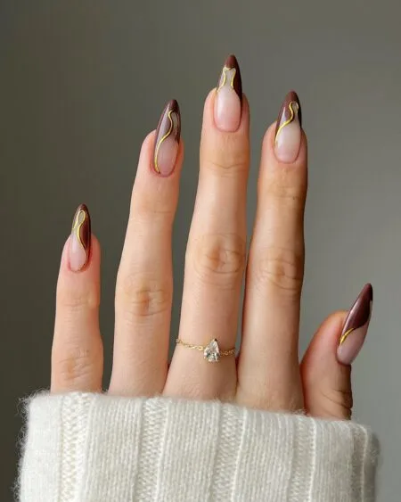 Nude nails with chocolate brown French tips.
