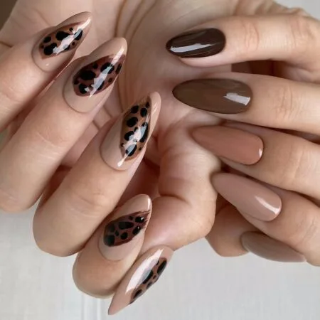 Caramel latte nails with warm brown swirl details.