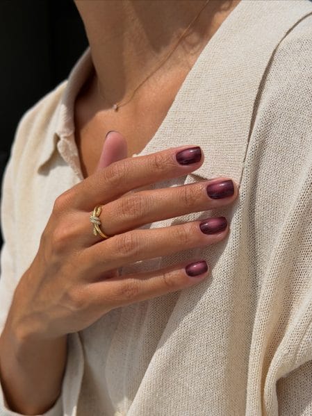 Short square nails coated in deep burgundy velvet magnetic polish with a lit-from-within halo