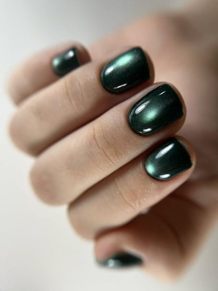 Emerald forest green magnetic cat-eye polish across softly rounded square nails