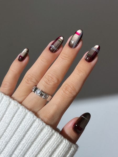Taupe cat-eye magnetic nails with sheer oxblood tips and fine white plaid lines
