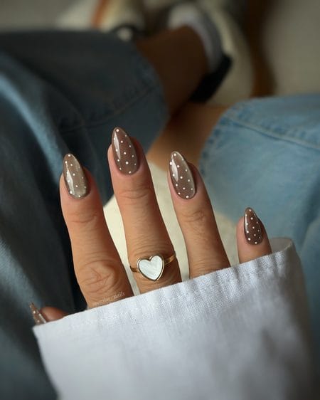 Taupe velvet cat-eye nails with white polka dot accents