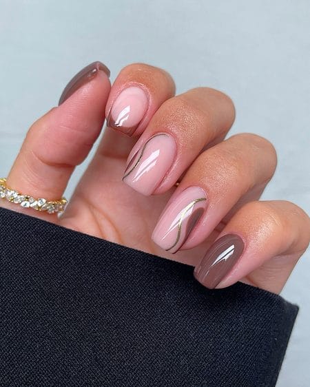 Milk chocolate nails with mocha swirls and metallic gold outlines