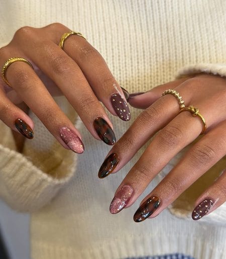 Tortoiseshell nails with aubergine brown, gold flakes, and rose-gold shimmer