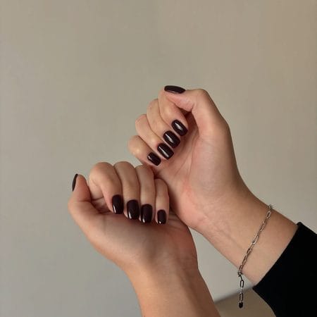 Short dark espresso brown nails with a glossy squoval finish