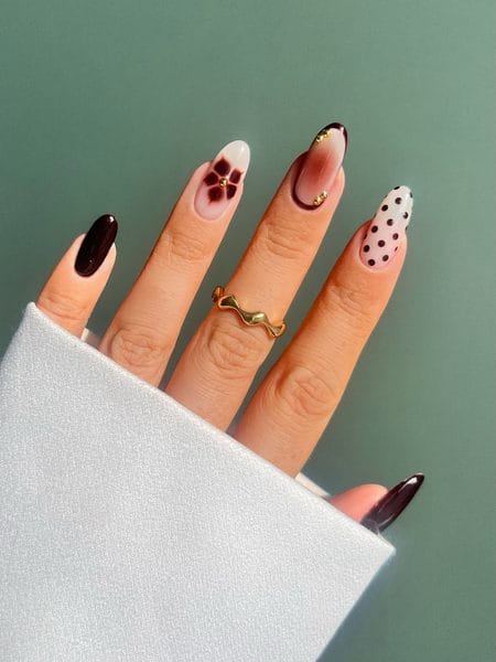 Espresso aura nails with black and white polka dot accent and gold details